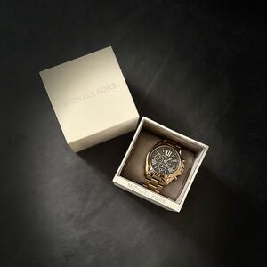 Michael Kors Gold with Black Watch. Brings extra links for sizing of your wrist